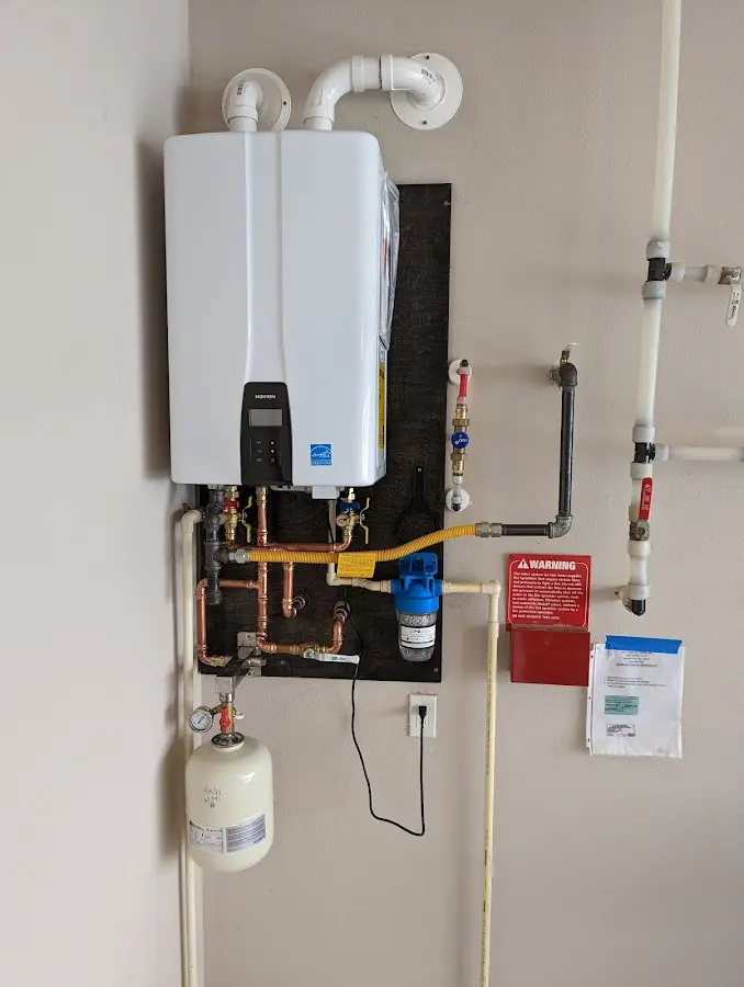 Professional plumber installing copper piping in a Uniontown home